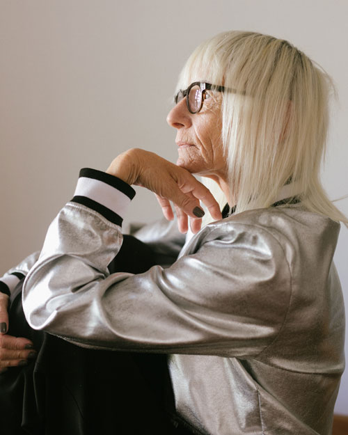 Picture of an older woman sitting facing the left. Right hand hugging her knee and left hand under her chin. This picture is being used as the feature image for the OSher Lifelong Learning Institute(OLLI).