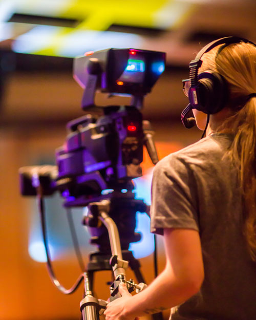 a girl using a professional videography equipment
