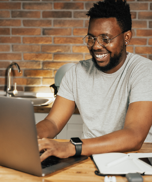 a man happily working on his laptop