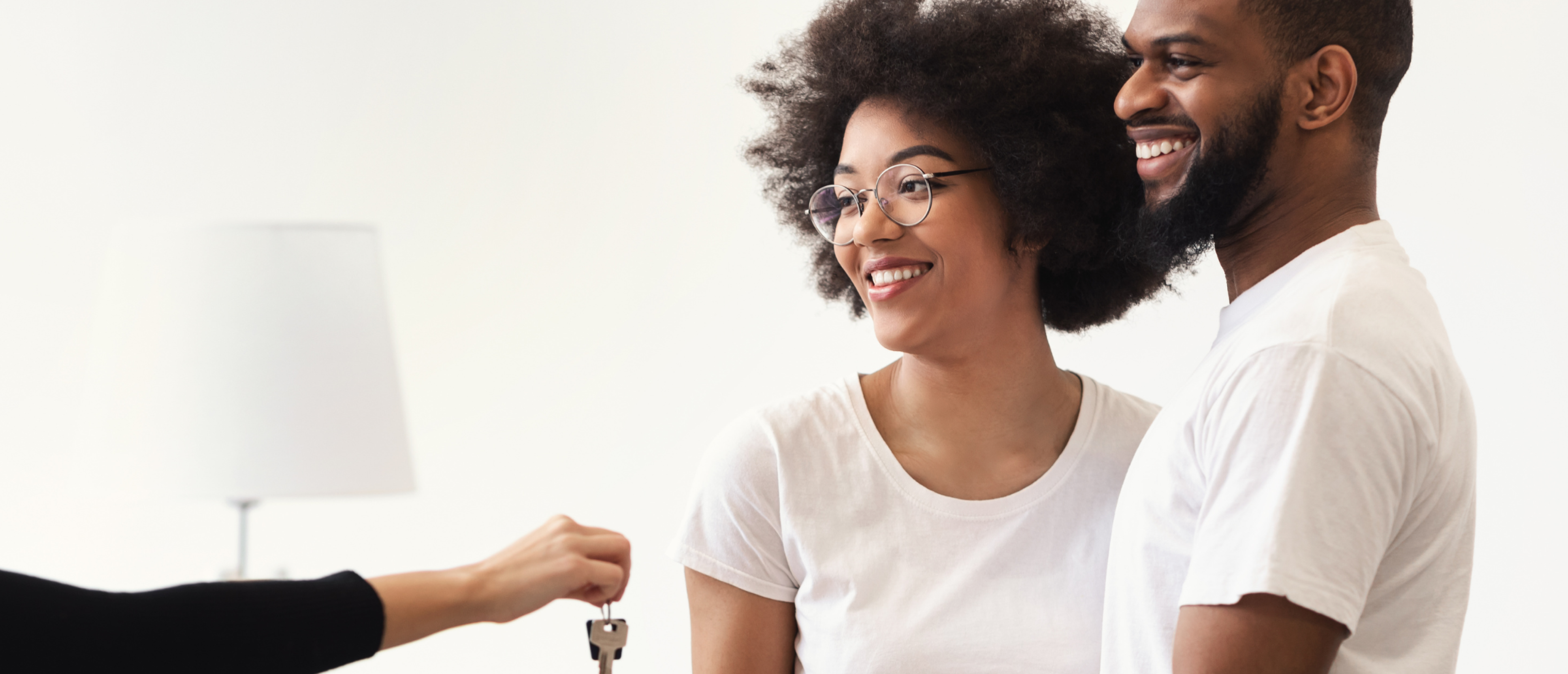 banner image showing a happy couple accepting keys to their new home