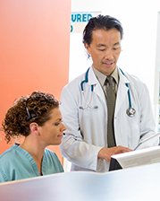 a doctor training a trainee at a desk