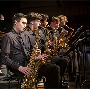 young men playing saxophones