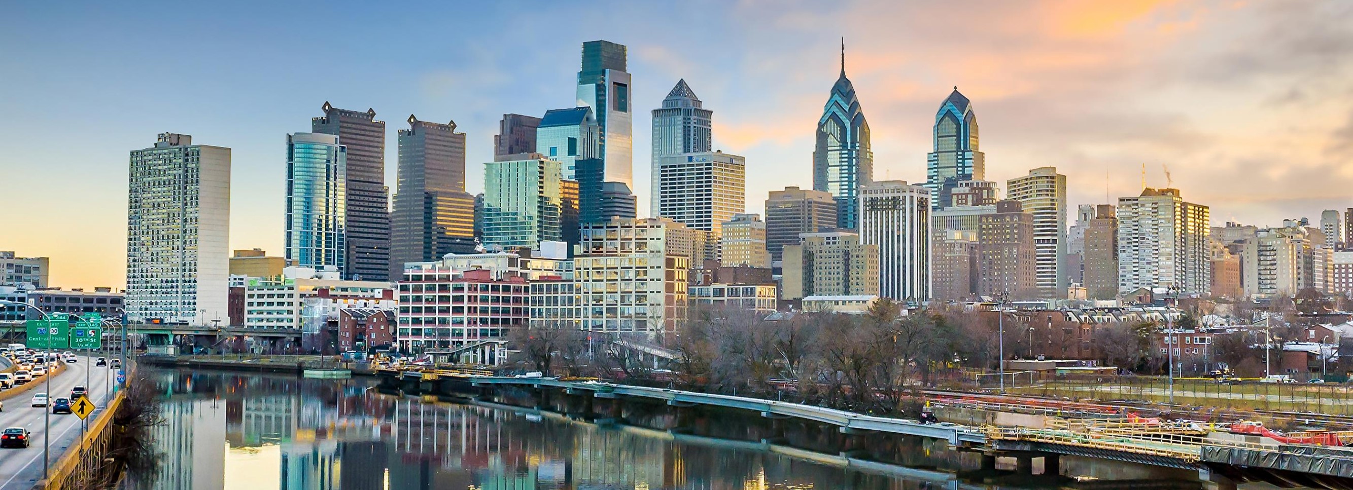 Picture of the Philadelphia Skyline with a sunrise backdrop